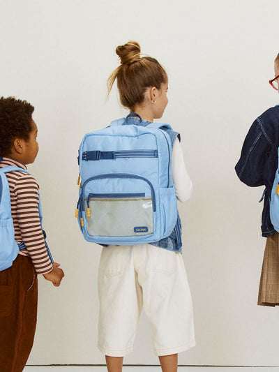 CALPAK Kids Medium Backpack in Blue for ages 5-8 is built for your little one’s big days with dark blue zippers and yellow mesh front pocket, multiple interior pockets, and padded comfort straps; CKBM2501-BLUE view 2