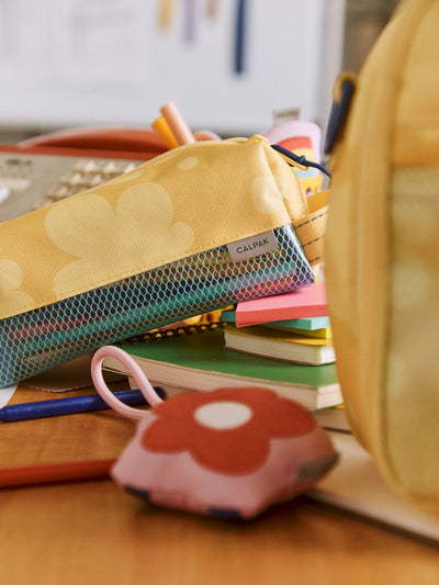 CALPAK Kids Pencil Case in yellow with tan flower print in Yellow Bloom front view with yellow zippers and blue mesh front pocket; CKPC2501-YELLOW-BLOOM view 2