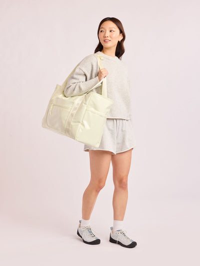 CALPAK Terra 35L Tote Bag with multiple pockets and shoulder straps in shiny white Moonbeam on a white background; TTO2401-MOONBEAM view 2