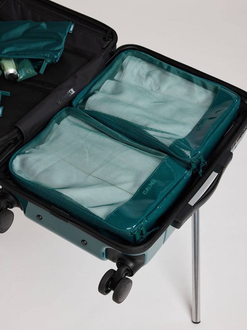 CALPAK Terra 5pc Packing Cube Set in blue green Kale packed in a suitcase