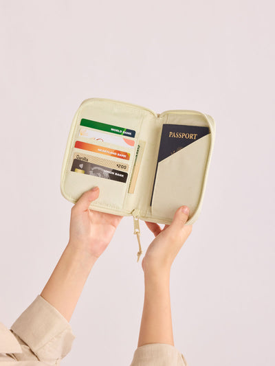 Front side of CALPAK Terra Zip Passport Wallet in shiny white Moonbeam; ATPW2501-MOONBEAM view 2