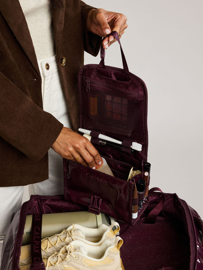 CALPAK Terra Hanging Toiletry Bag to store makeup and toiletries in dark red  Dark Cherry on a white background; THY2201-DARK-CHERRY view 2