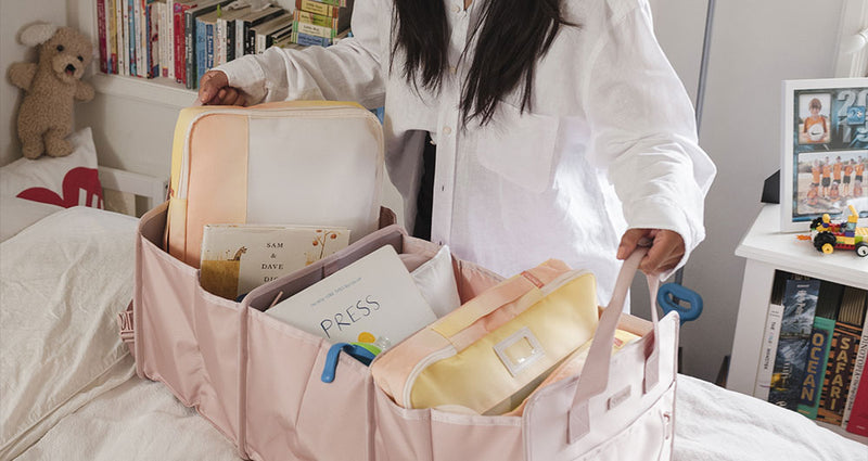 Model organizing items into a pink CALPAK Car Organizer