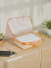 CALPAK compression packing cubes with handles in wavy orange print; PCC2201-RETRO-SUNSET